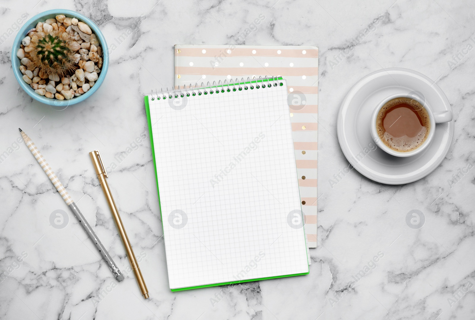 Photo of Flat lay composition with notebooks and cup of coffee on marble background