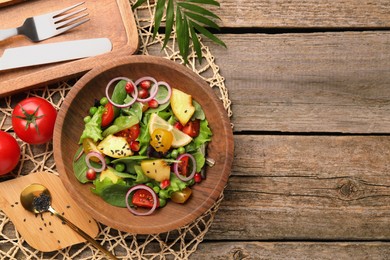 Photo of Delicious salad with peach, green peas and vegetables served on wooden table, flat lay. Space for text