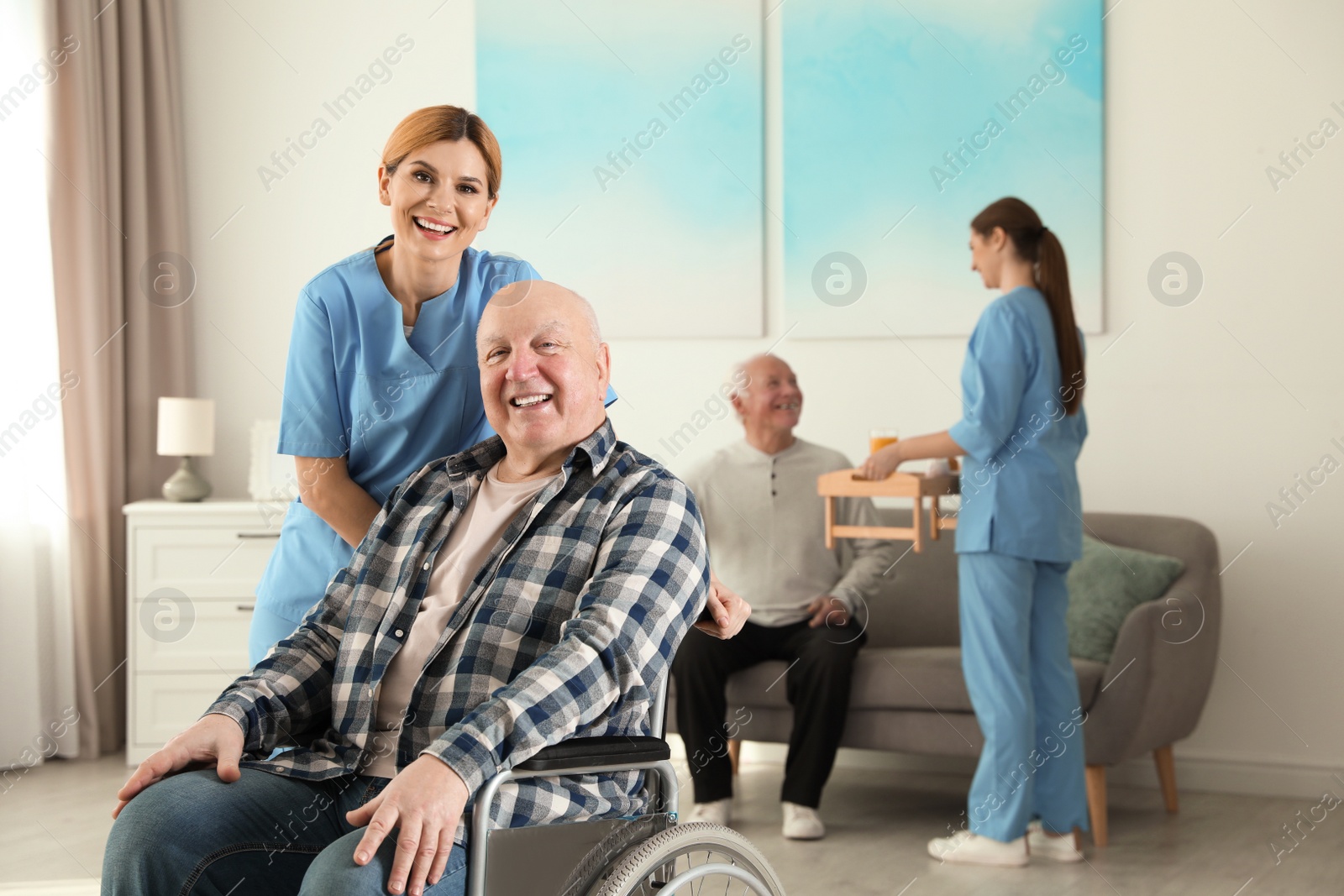 Photo of Nurses assisting elderly people at retirement home