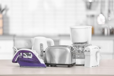 Photo of Household and kitchen appliances on table indoors. Interior element