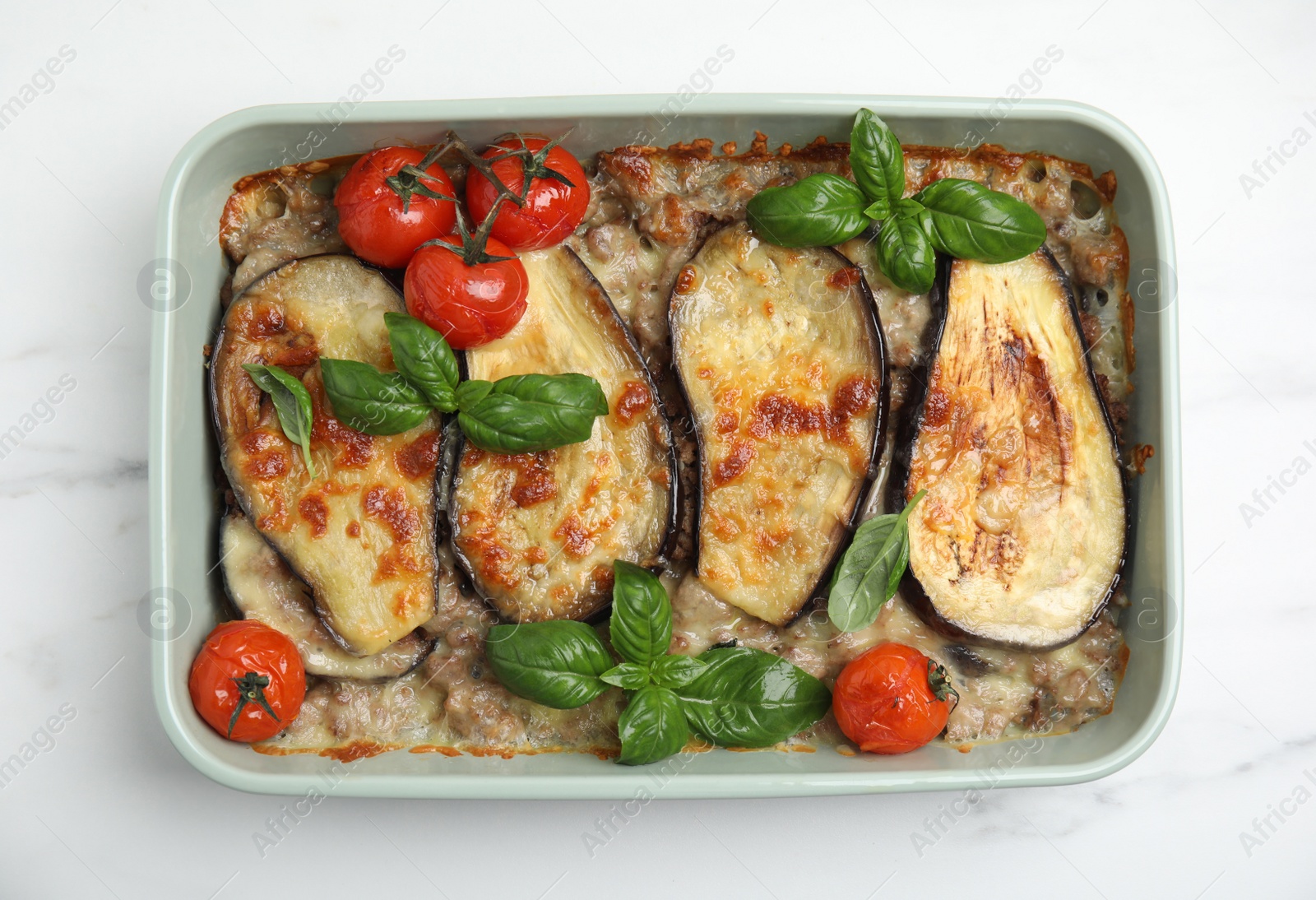 Photo of Delicious eggplant lasagna in baking dish on white marble table, top view