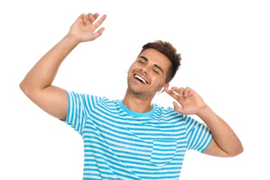 Photo of Happy young man listening to music through wireless earphones on white background