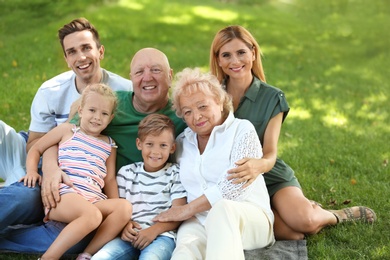 Photo of Couple with children and elderly parents in park