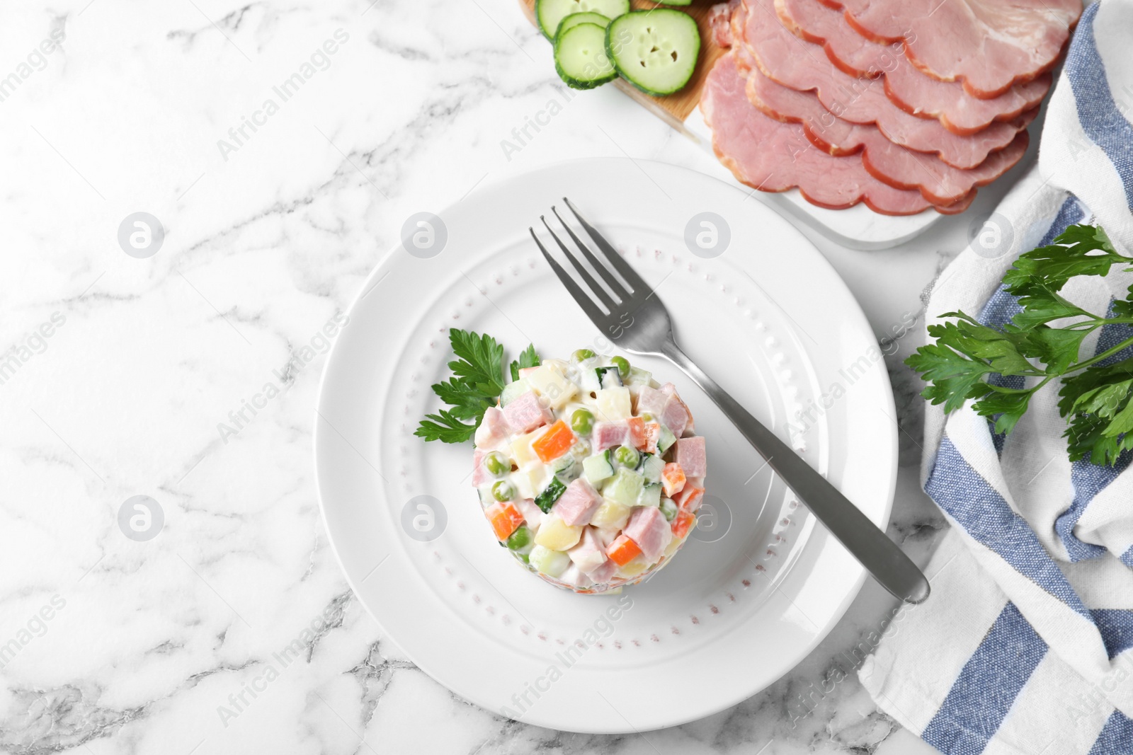 Photo of Delicious salad Olivier on table, flat lay