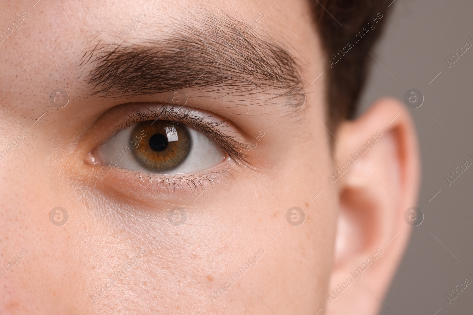 Photo of Man with beautiful eyes on grey background, closeup