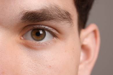 Photo of Man with beautiful eyes on grey background, closeup