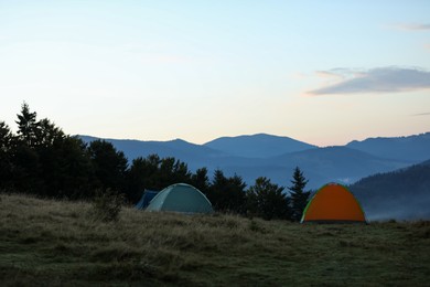 Photo of Camping tents in mountains on early morning