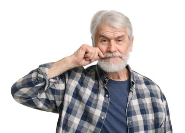 Senior man touching mustache on white background