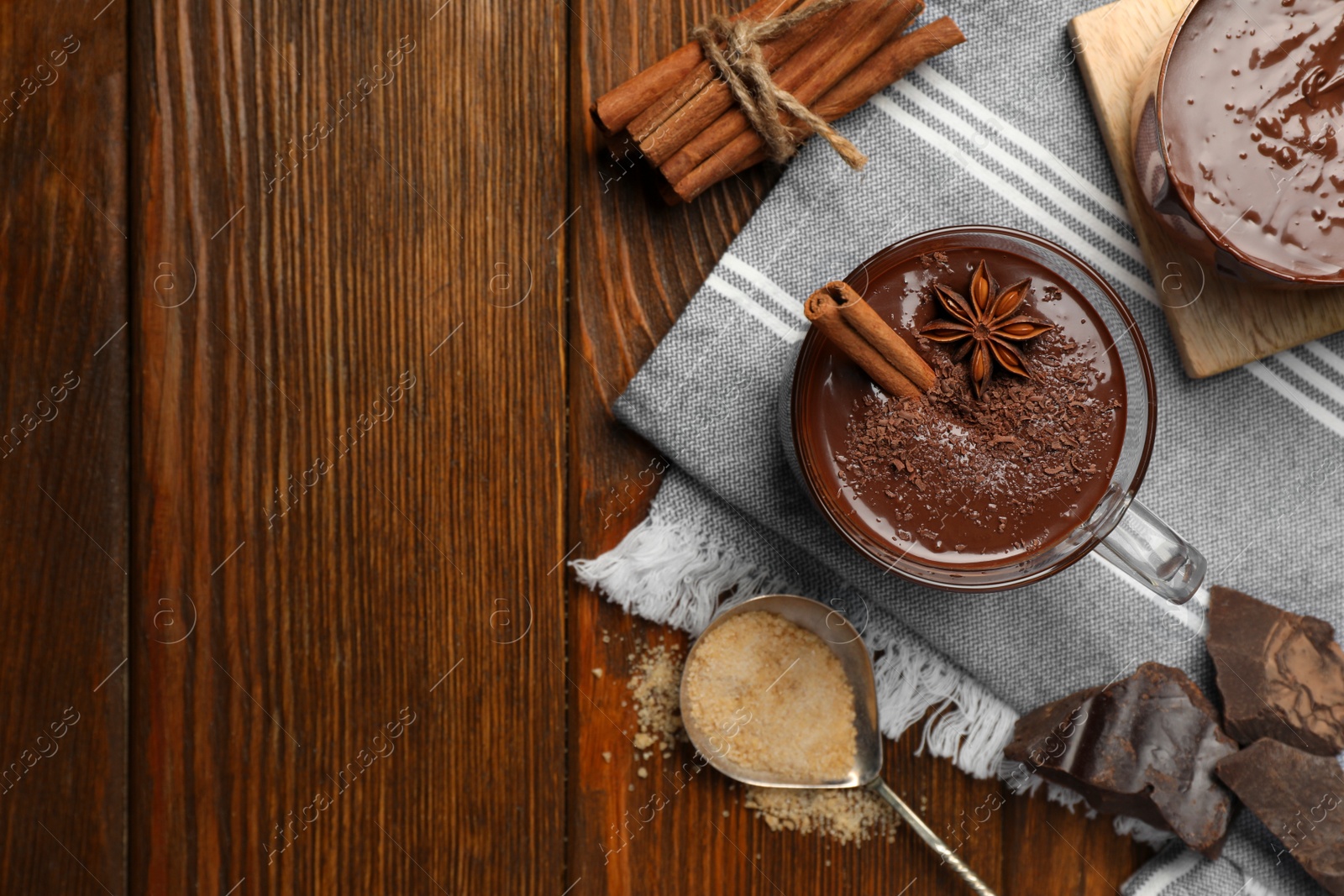 Photo of Flat lay composition with cups of delicious hot chocolate on wooden table, space for text