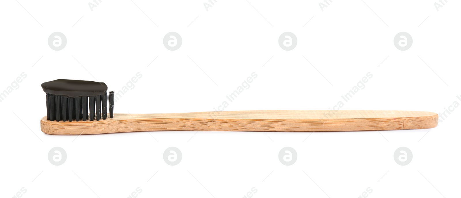 Photo of Bamboo toothbrush with charcoal paste isolated on white