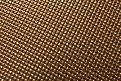 Textured golden surface as background, top view
