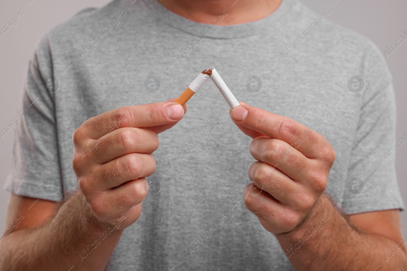 Photo of Stop smoking concept. Man breaking cigarette, closeup