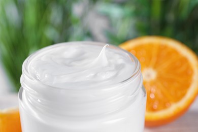 Photo of Jar of hand cream on blurred background, closeup