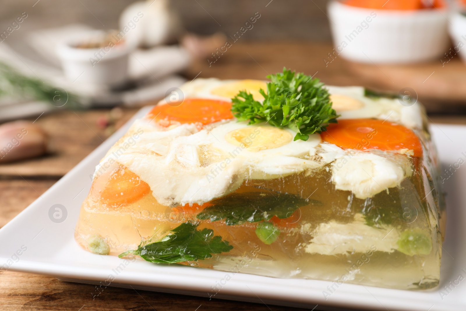 Photo of Delicious fish aspic with parsley on plate, closeup