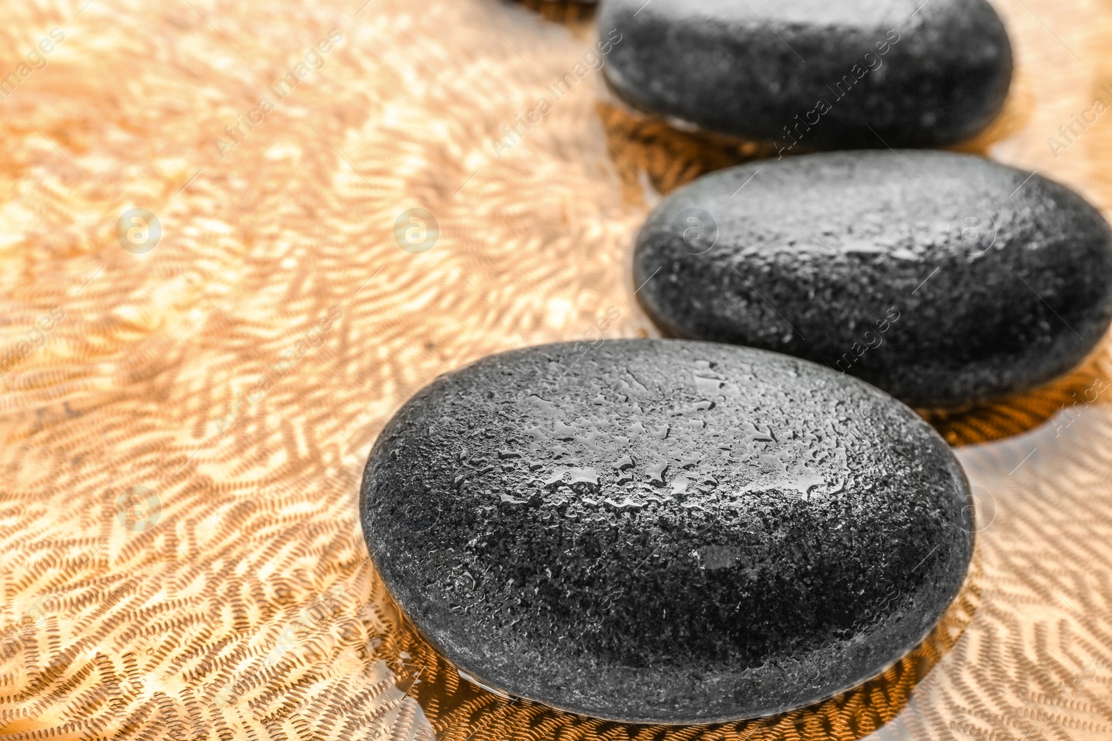 Photo of Stones in water, closeup view. Zen lifestyle