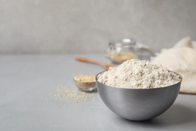 Photo of Bowl with sesame flour on table