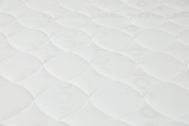 Modern comfortable orthopedic mattress as background, closeup