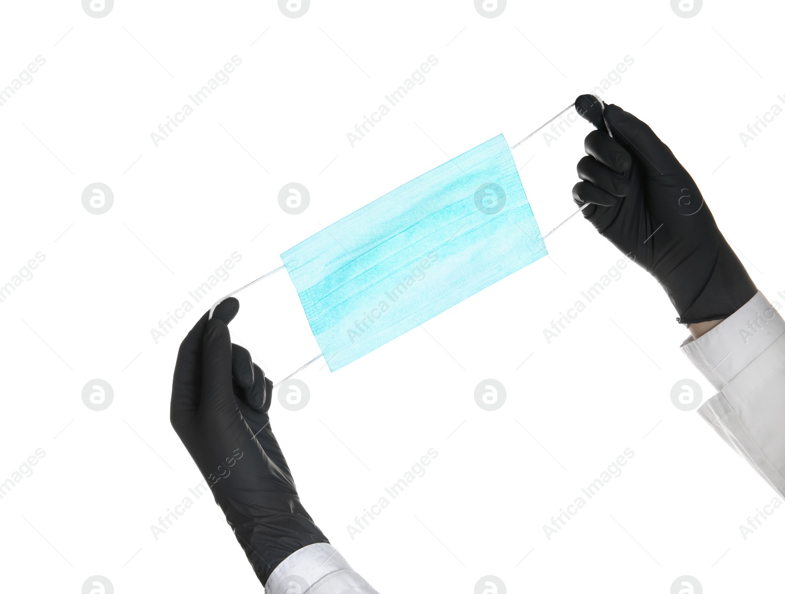 Photo of Doctor in sterile gloves holding medical face mask on white background