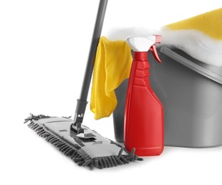 Photo of Plastic bucket with foam and cleaning supplies on white background