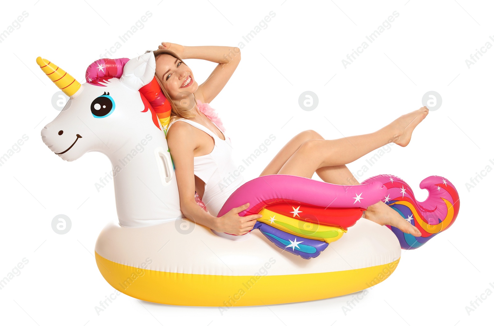 Photo of Beautiful young woman in stylish bikini with  unicorn inflatable ring on white background