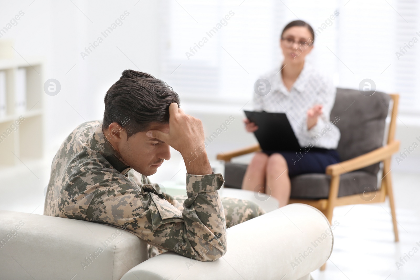 Photo of Male military officer having appointment with psychotherapist in office