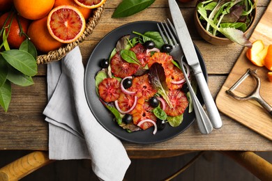 Delicious sicilian orange salad served on wooden table, flat lay