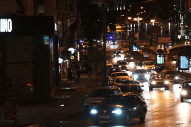 Photo of KYIV, UKRAINE - MAY 22, 2019: View of illuminated city street with road traffic