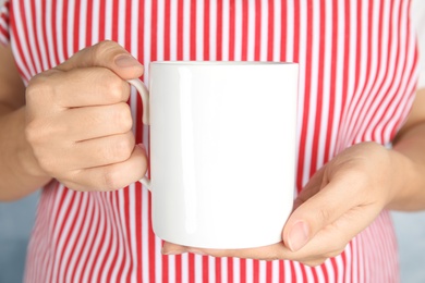 Woman holding ceramic cup, closeup. Mock up for design