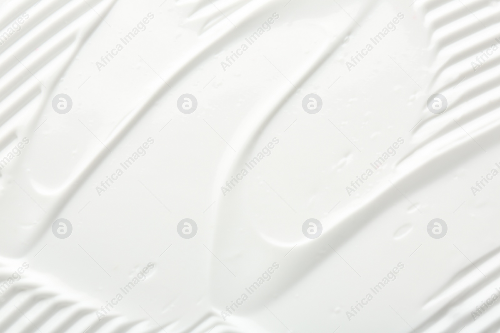 Photo of Texture of face care cream as background, top view