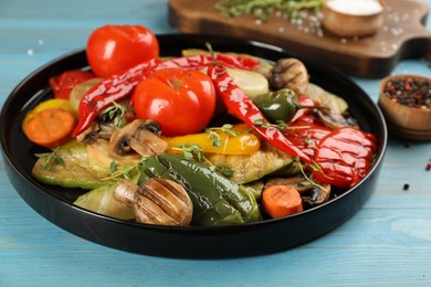 Photo of Delicious grilled vegetables on light blue wooden table, closeup