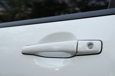 Photo of Closeup view of car door with handle