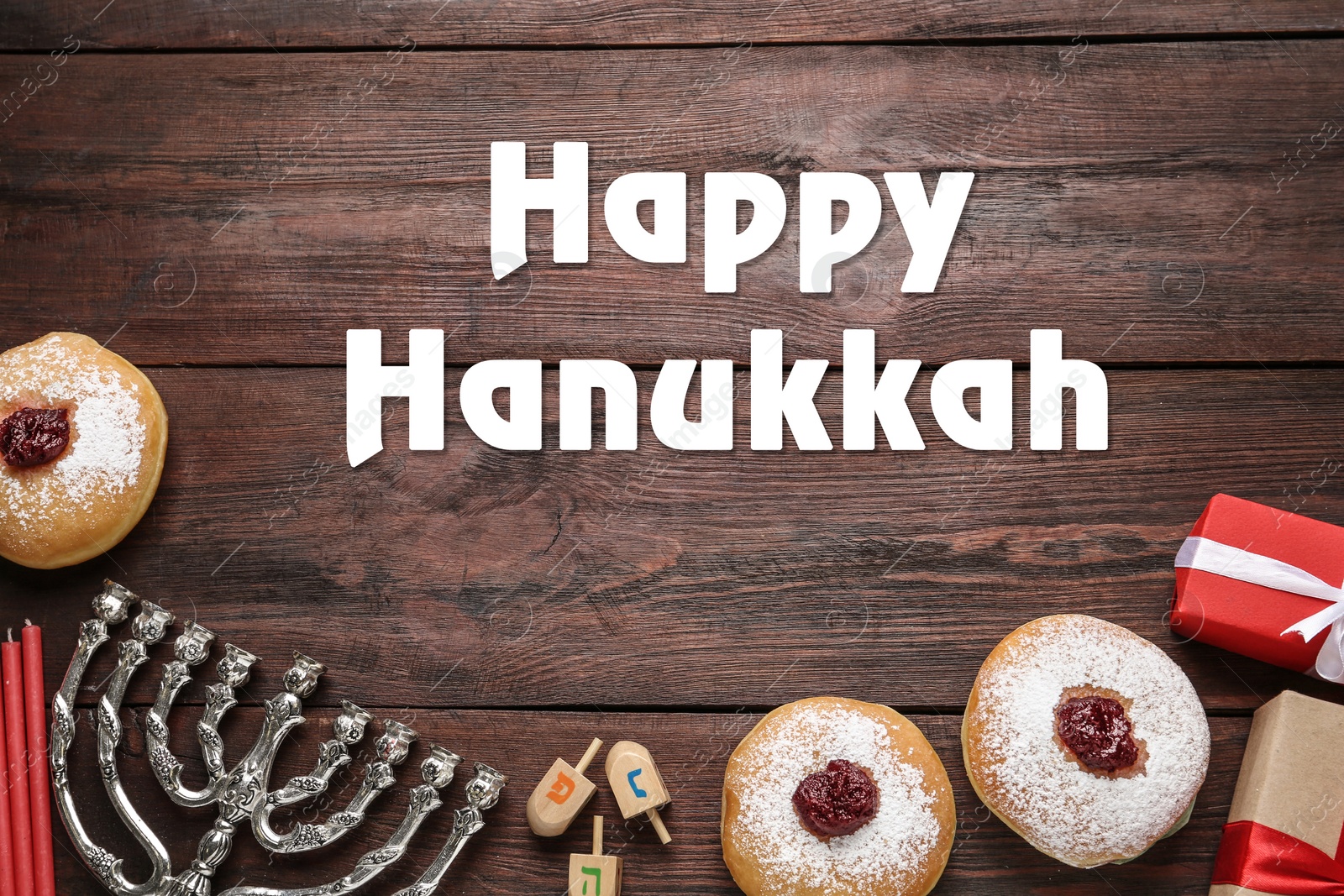 Image of Happy Hanukkah. Traditional menorah, candles, sufganiyot and dreidels on wooden background, flat lay 