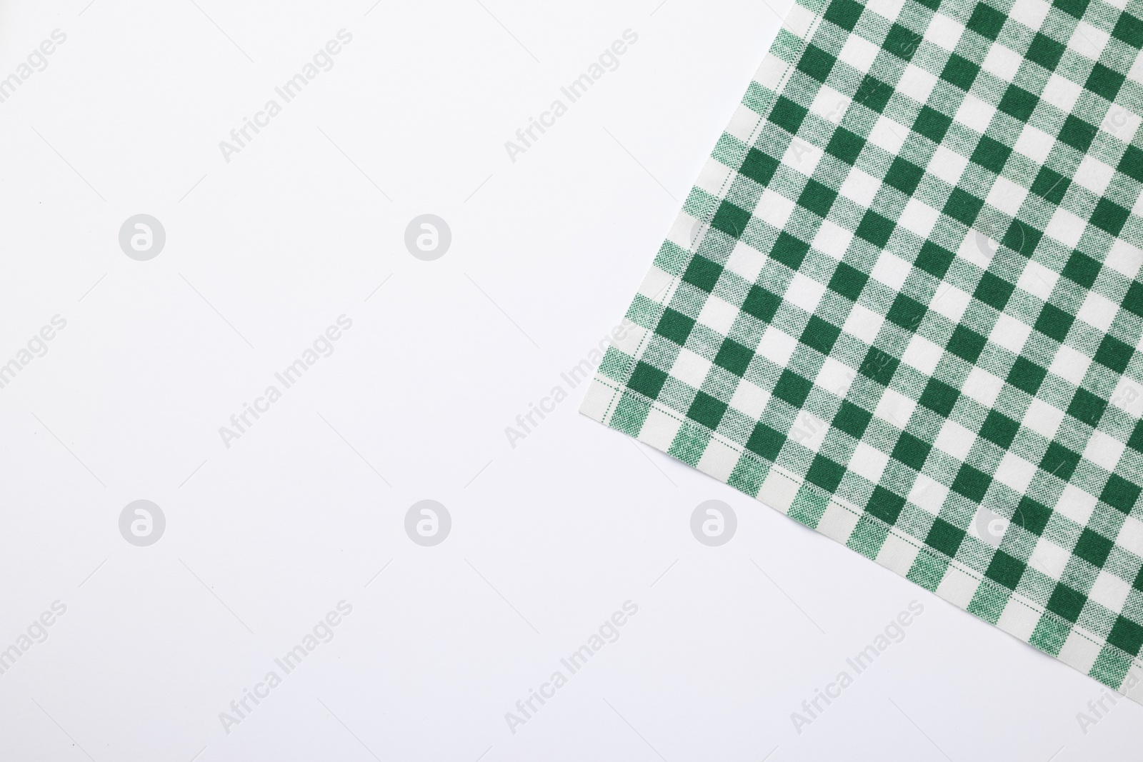 Photo of Green checkered tablecloth on white background, top view