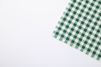 Green checkered tablecloth on white background, top view