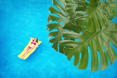 Image of View of beautiful green monstera leaves and young woman on inflatable mattress in swimming pool, above view