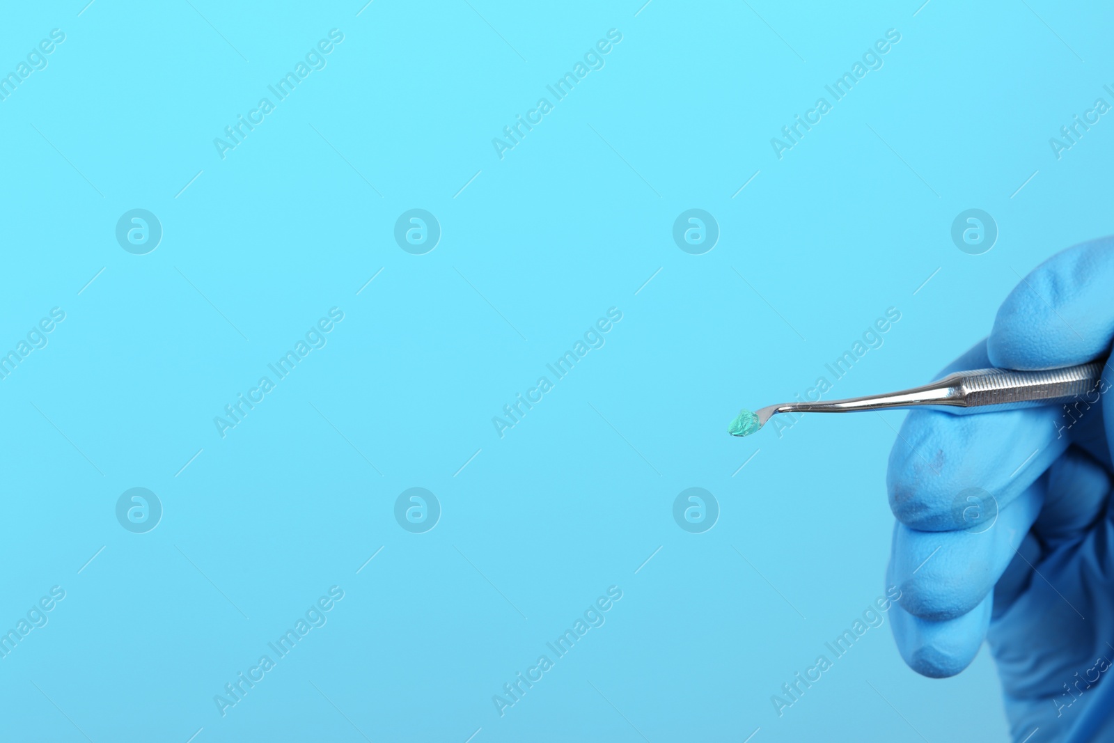 Photo of Dentist holding professional instrument on color background, space for text. Mouth and teeth care