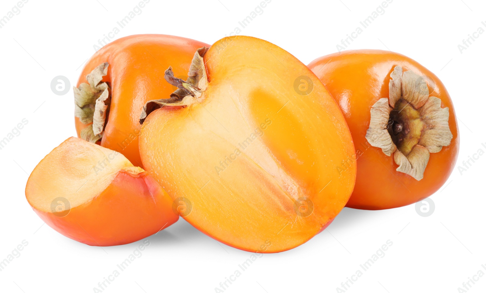 Photo of Whole and cut persimmon fruits isolated on white