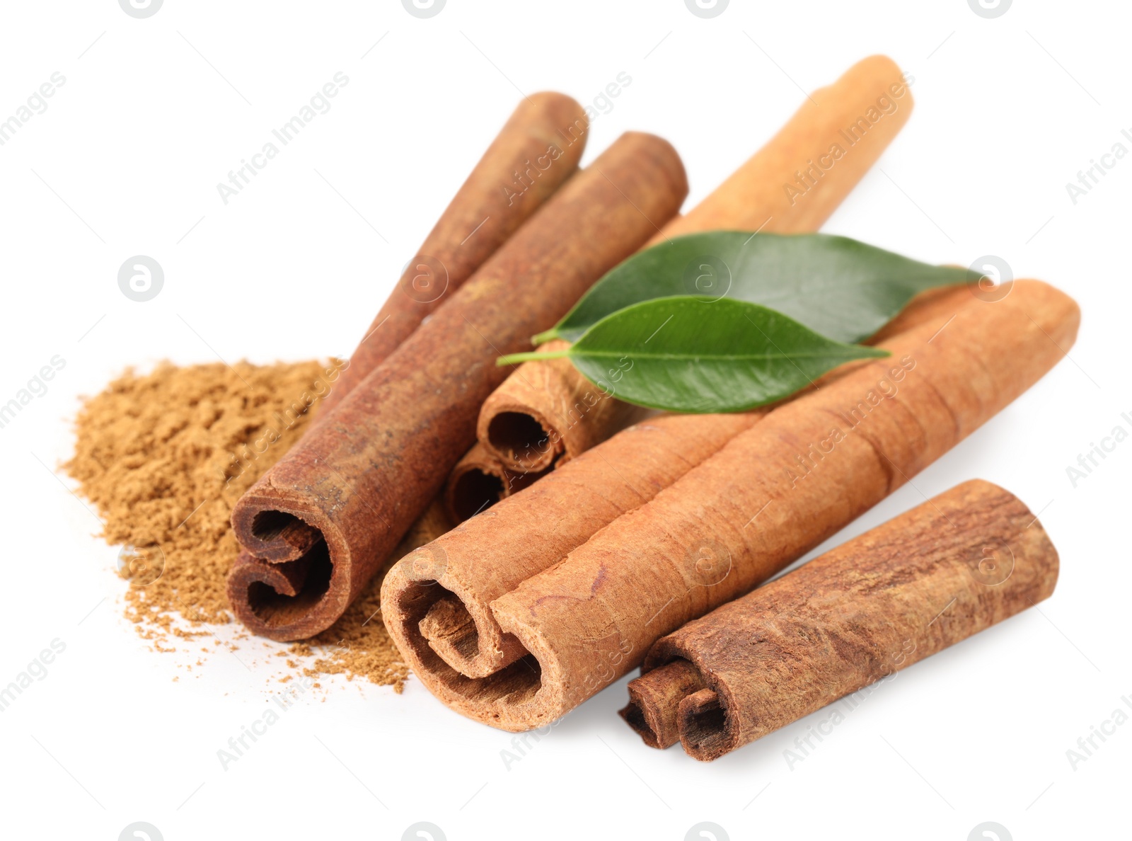 Photo of Dry aromatic cinnamon sticks, powder and green leaves isolated on white