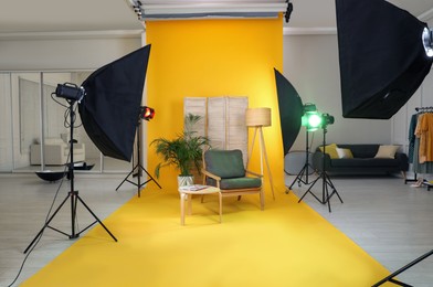 Stylish furniture in photo studio with professional equipment
