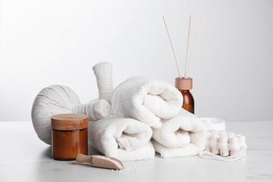 Spa composition with care products on white marble table