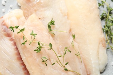 Fresh raw cod fish and microgreens, closeup