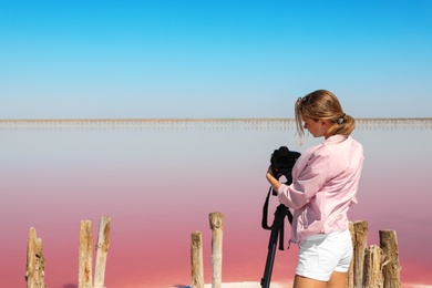 Photo of Professional photographer taking photo of pink lake on sunny day