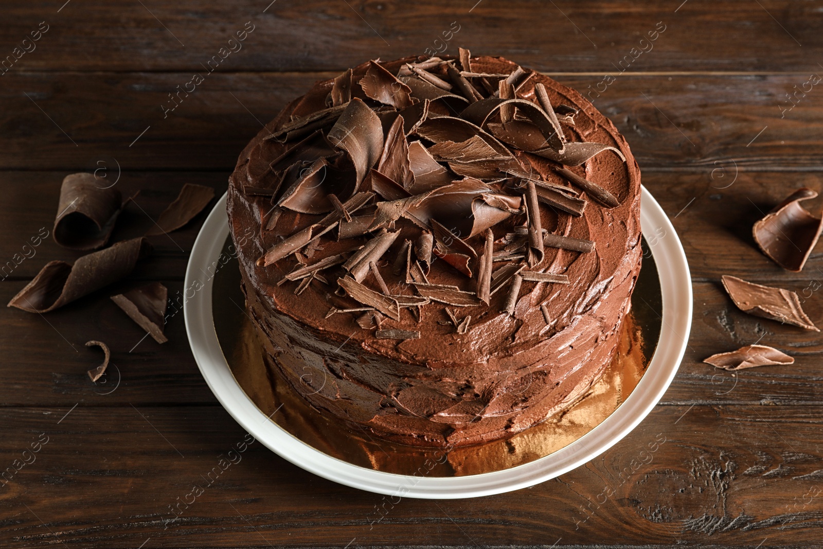 Photo of Plate with tasty homemade chocolate cake on wooden table