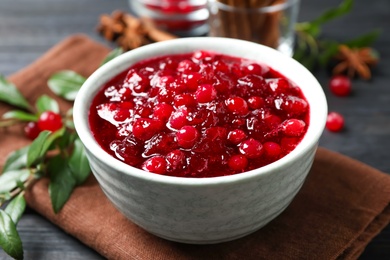 Photo of Fresh cranberry sauce served in bowl on table