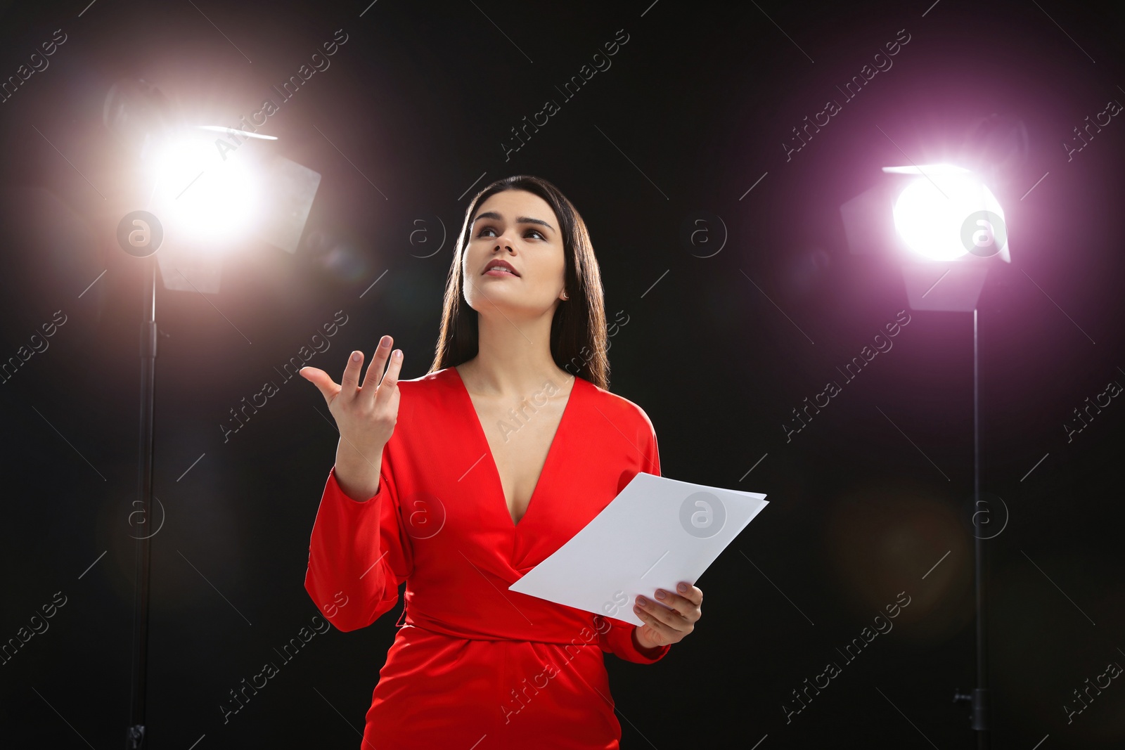 Photo of Actress with script performing on stage. Film industry