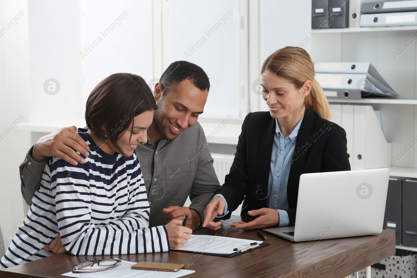 Photo of Couple consulting with professional notary in office