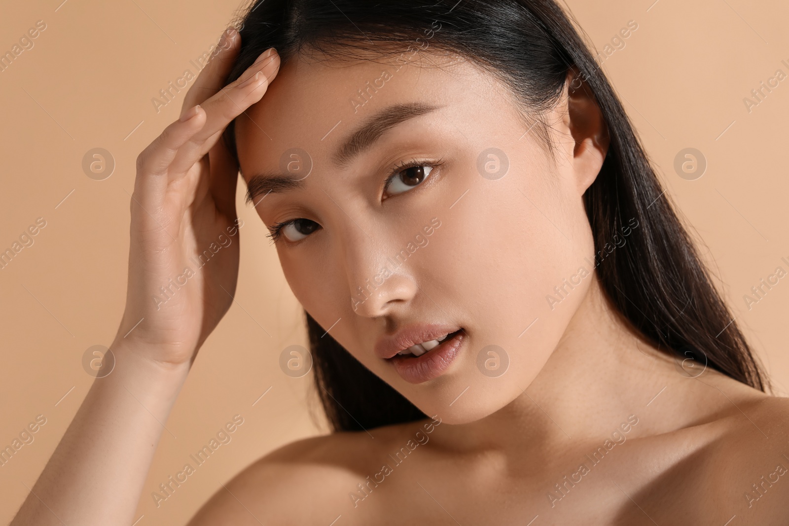 Photo of Beautiful young woman with makeup on beige background, closeup