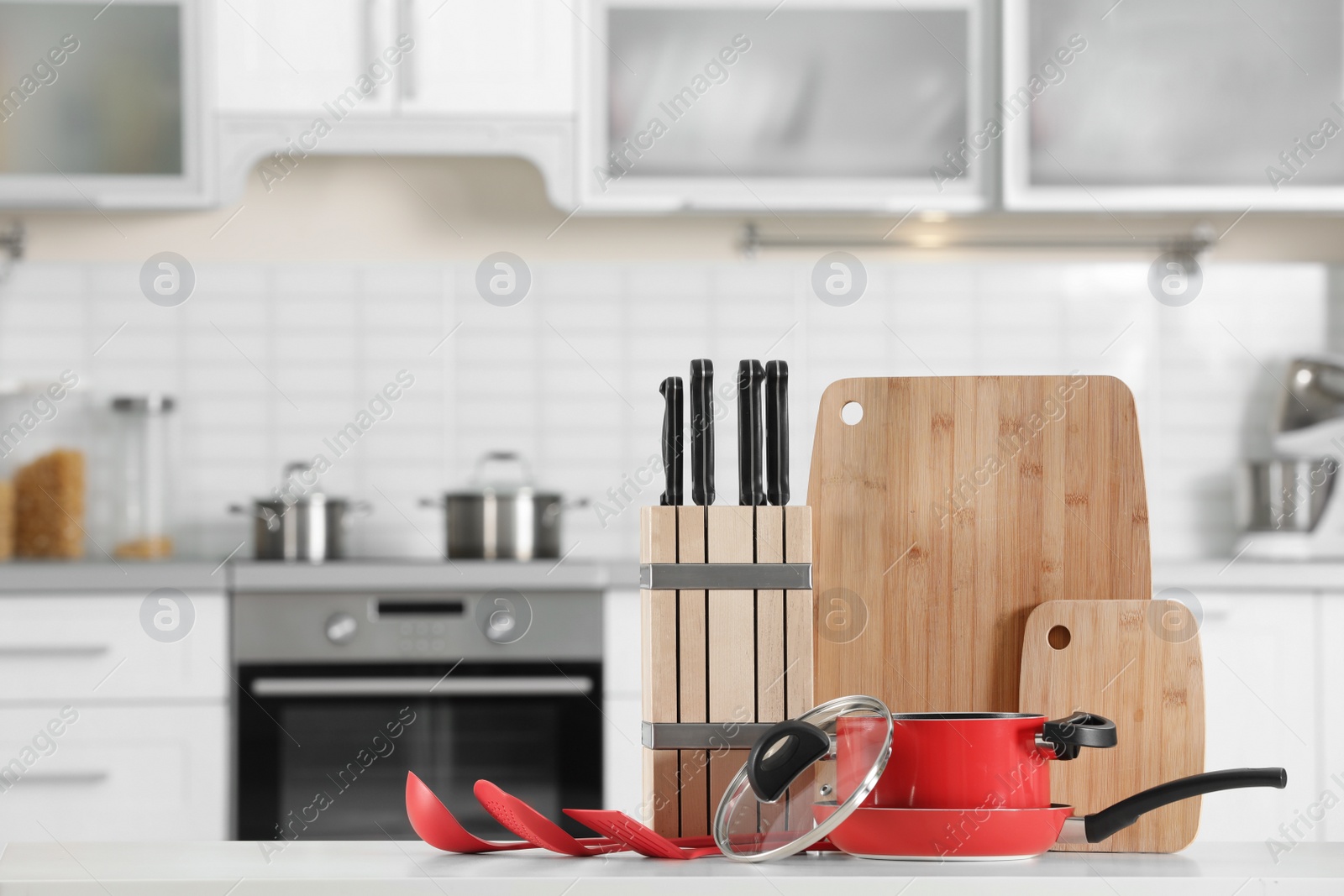 Photo of Set of clean cookware and utensils on table in kitchen. Space for text