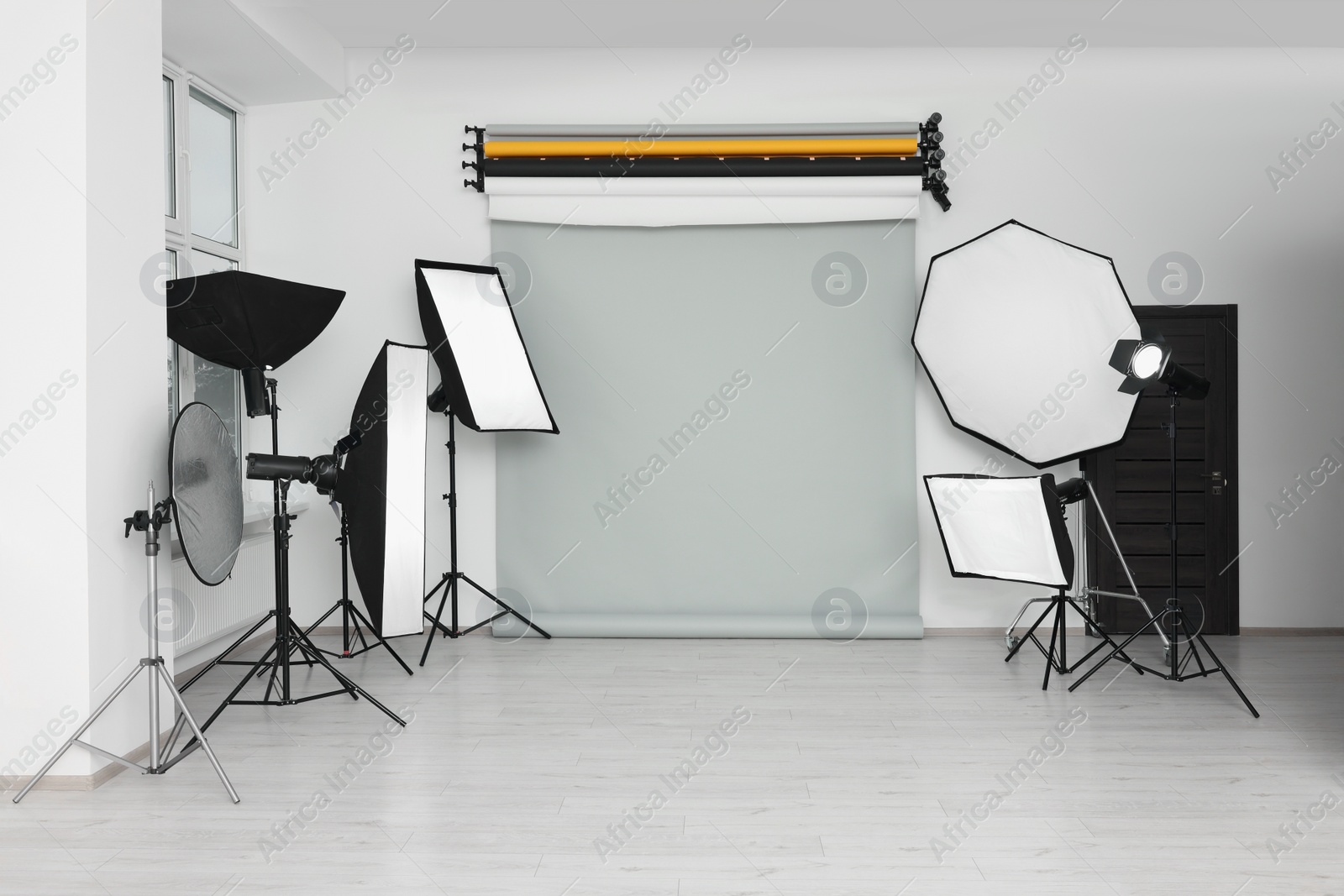 Photo of Interior of modern photo studio with professional lighting equipment