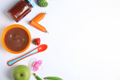 Flat lay composition with healthy baby food and ingredients on white background. Space for text